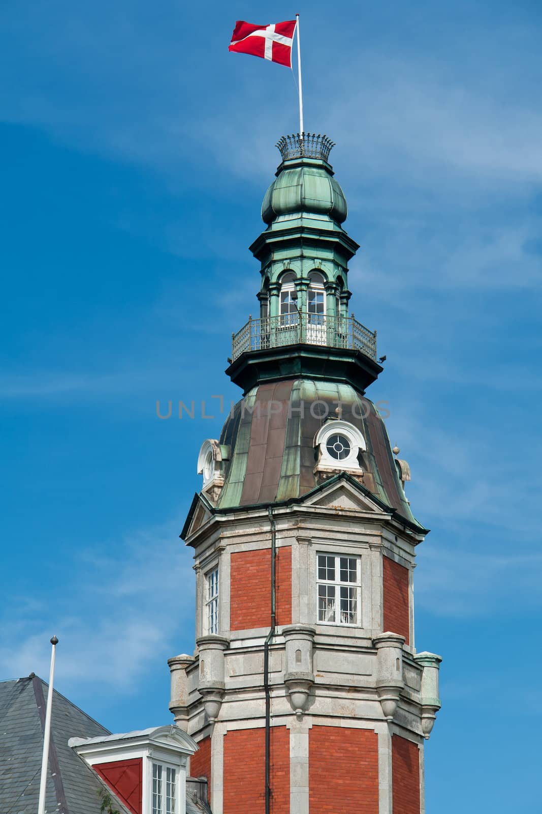 Flag of Denmark up high in the air with blue sky vertical background