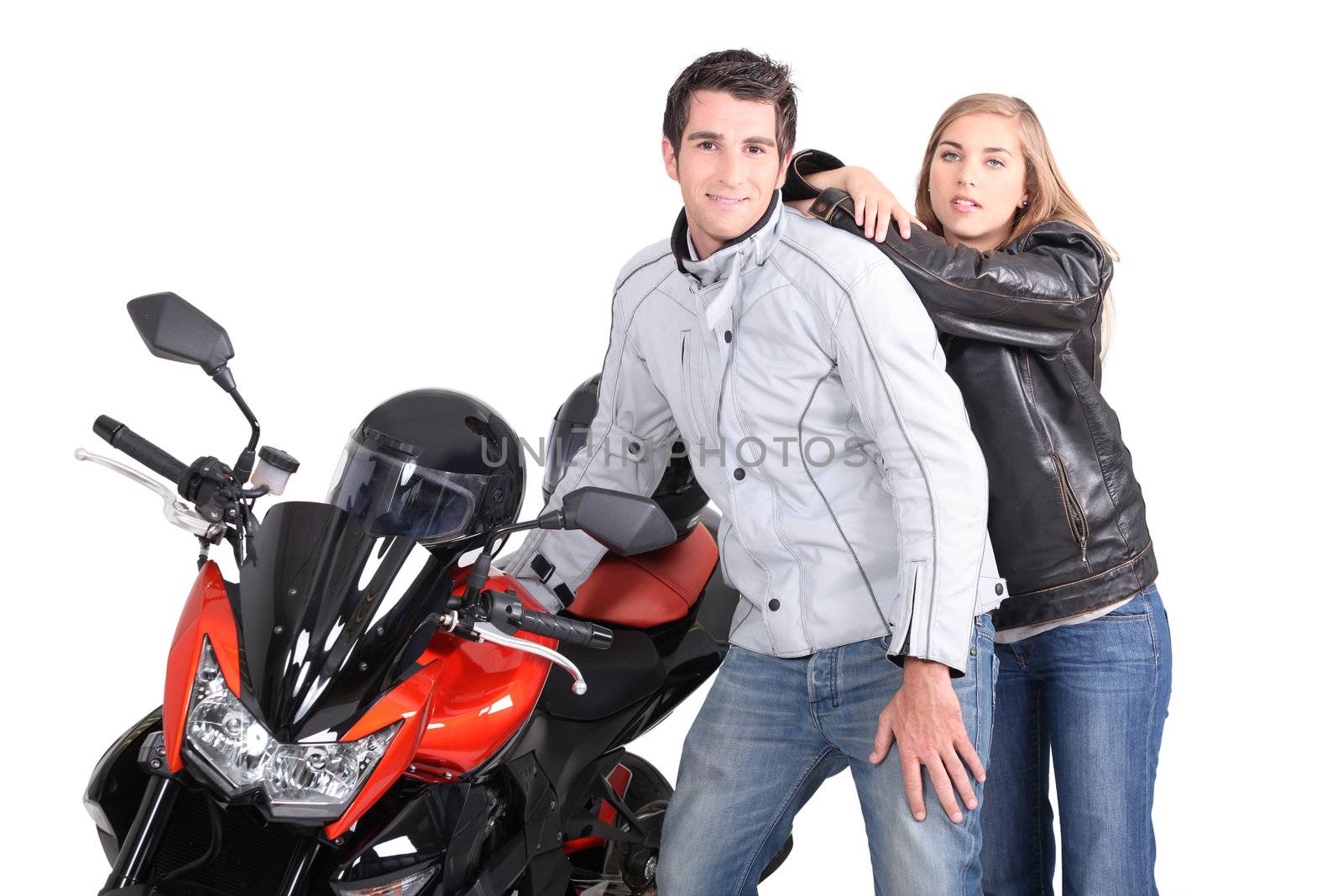 Couple posing next to motorcycle by phovoir
