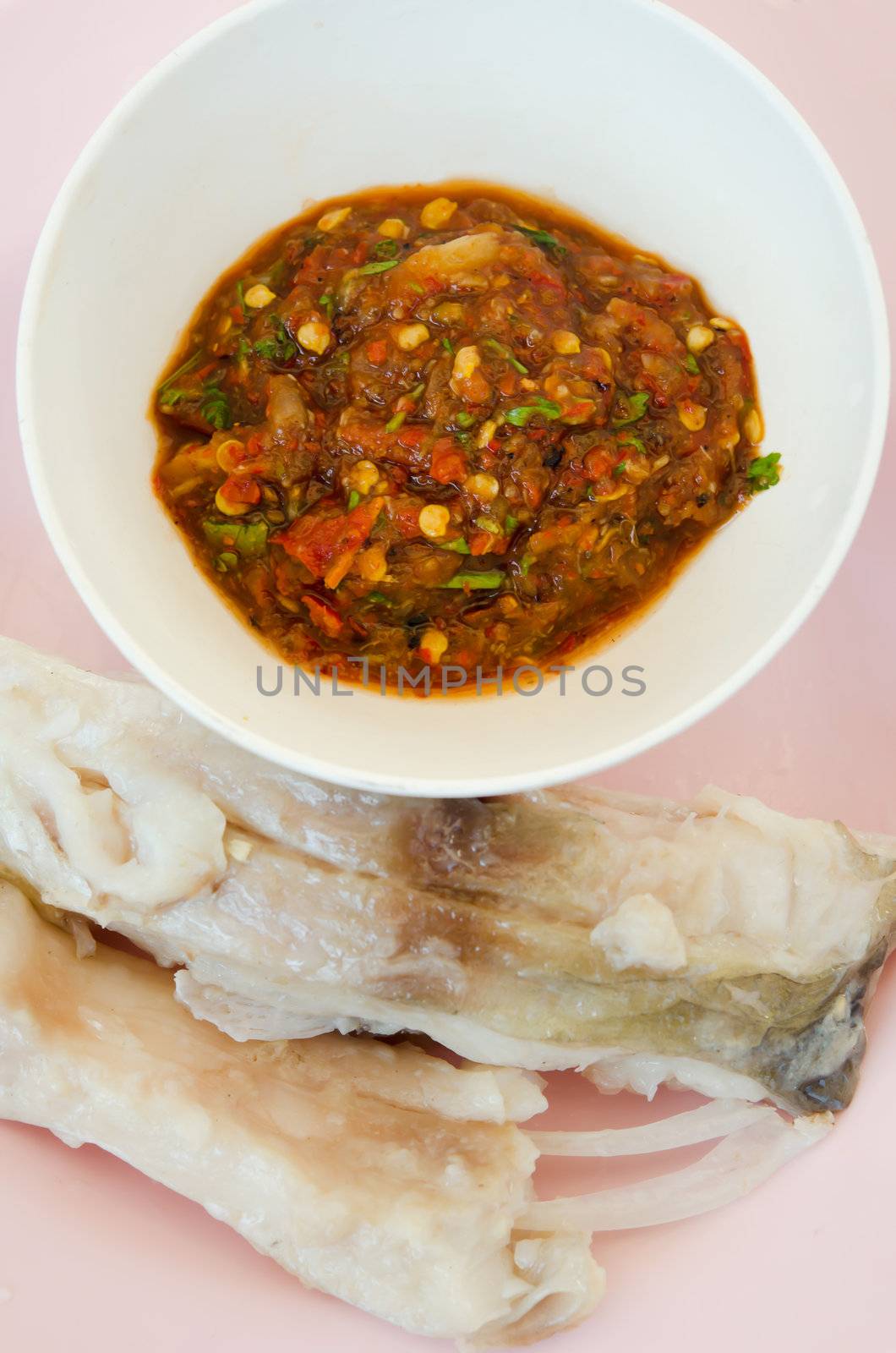 top view chili sauce and  fresh steam fish on pink dish