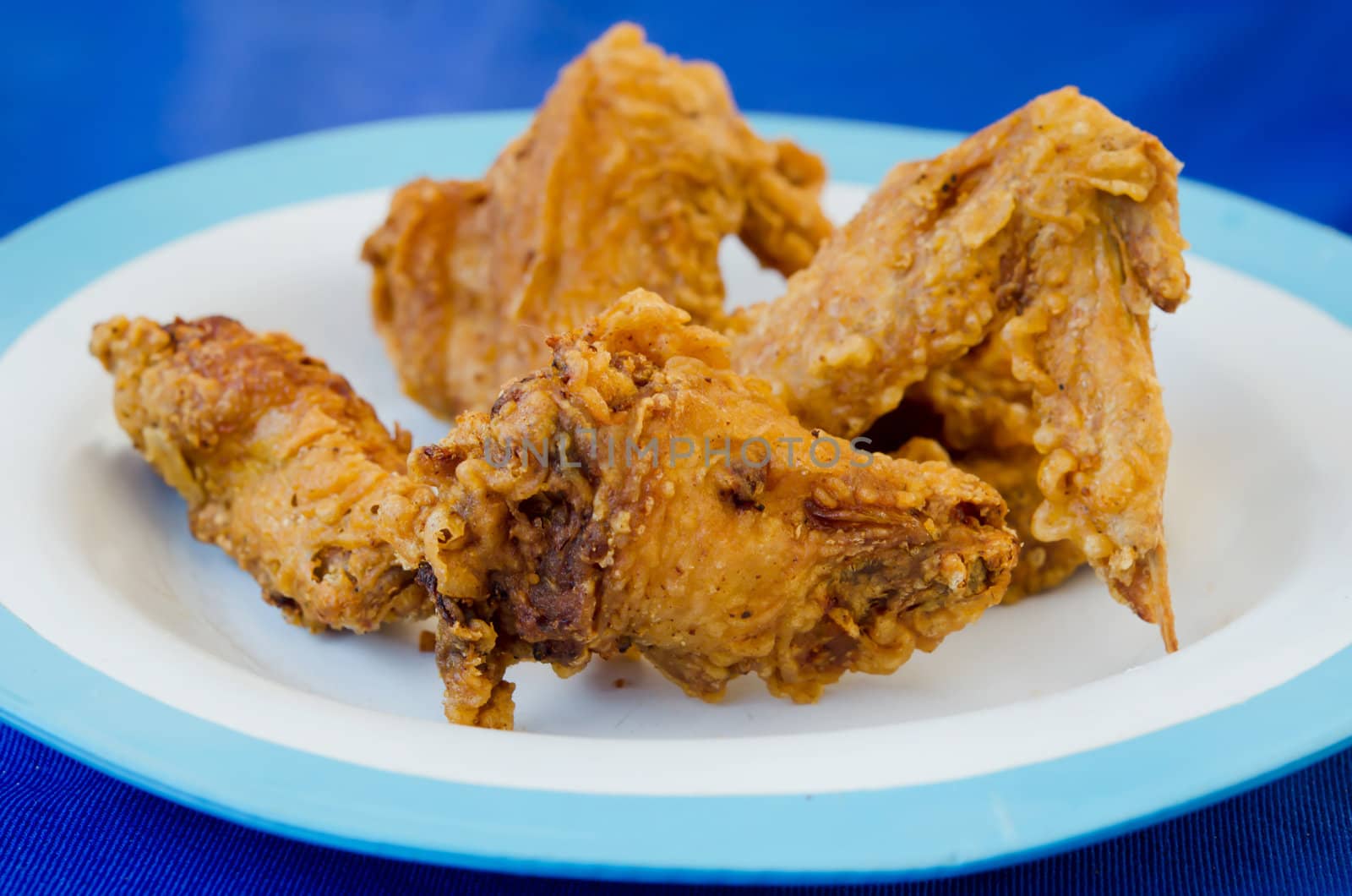 close up  fried  chicken  on dish , blue background