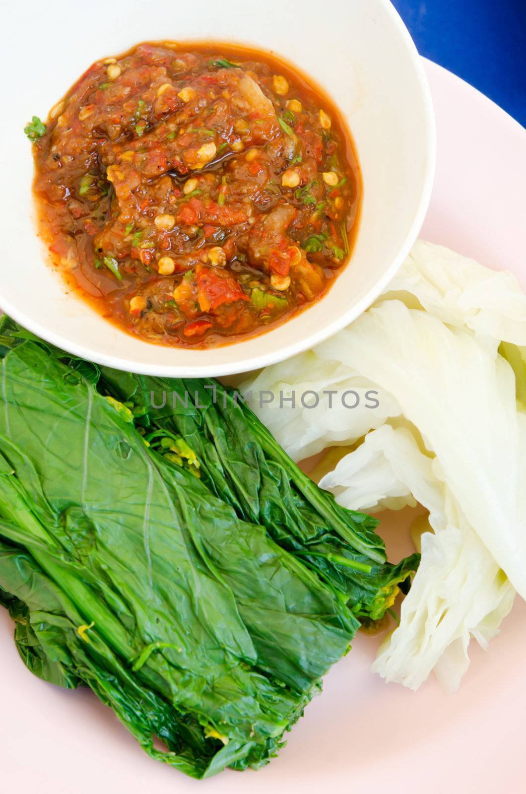 top view chili sauce and  fresh steam vegetable on dish