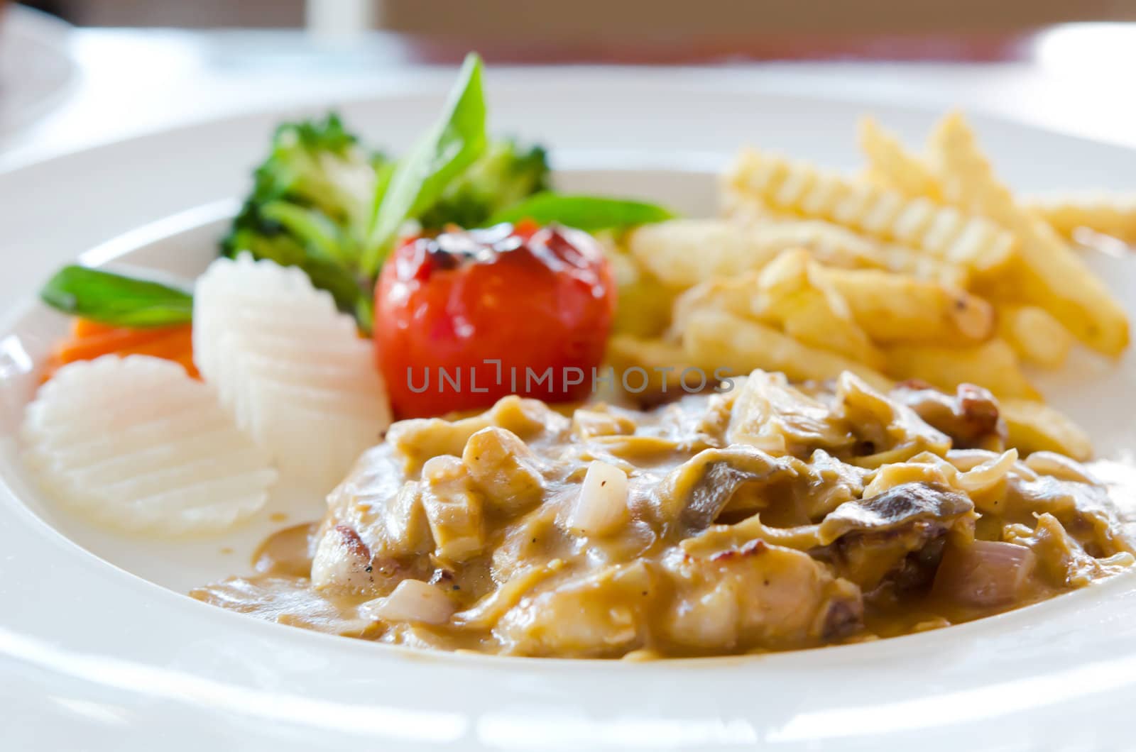 beef steak with mushrooms sauce and vegetable and french fries
