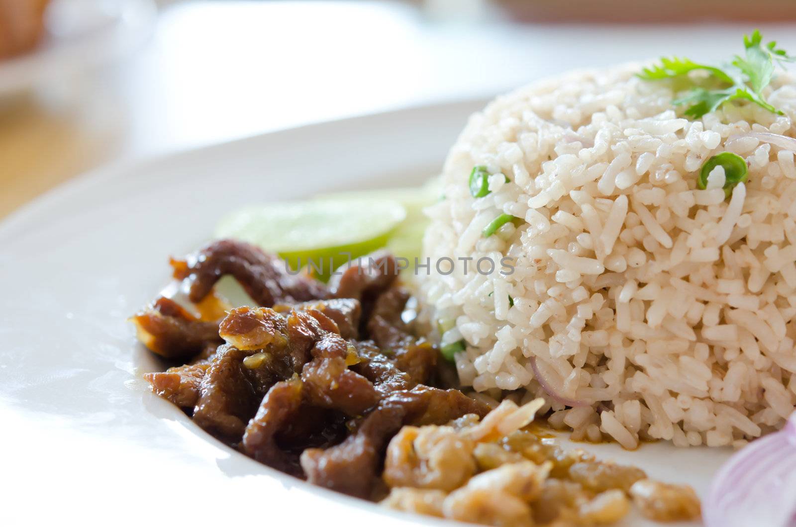 Mixed cooked rice with pork sauce and fresh vegetable , Thai favorite food of rice