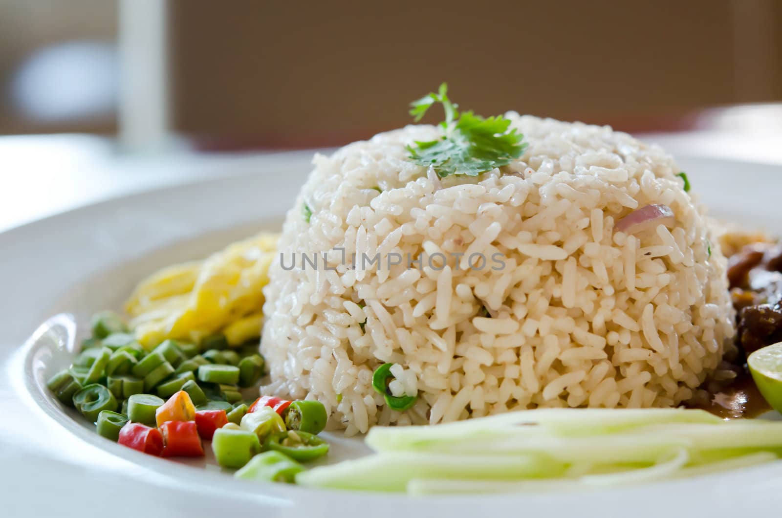 Mixed cooked rice with pork sauce , mango , chili, and fresh vegetable