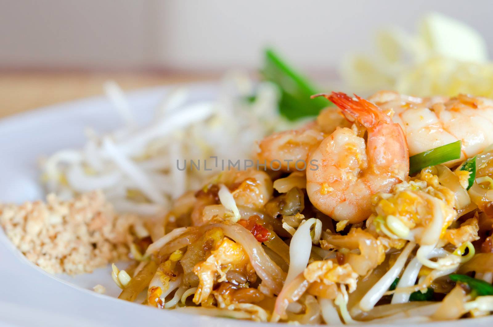 Stir fry noodles with shrimp , egg  and vegetable on white dish