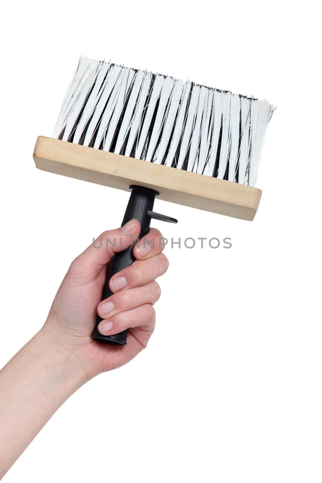 Hand holding a wallpaper brush by phovoir
