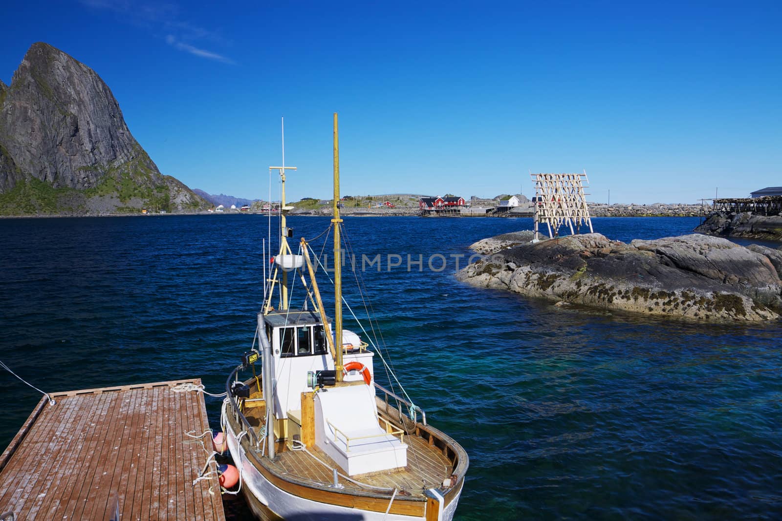 Traditional fishing boat in scenic harbor on Lofoten islands in Norway