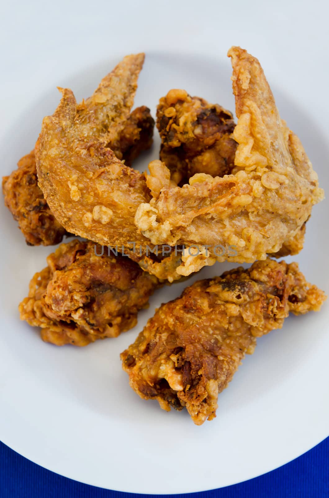 top view fried  chicken  on dish , blue background