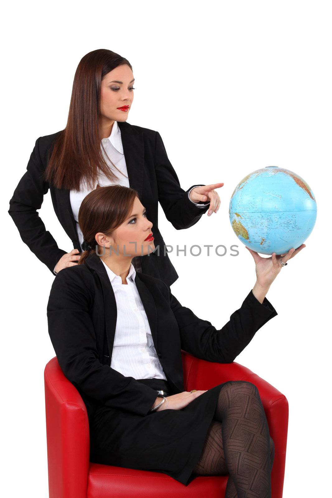 duo of businesswomen with globe