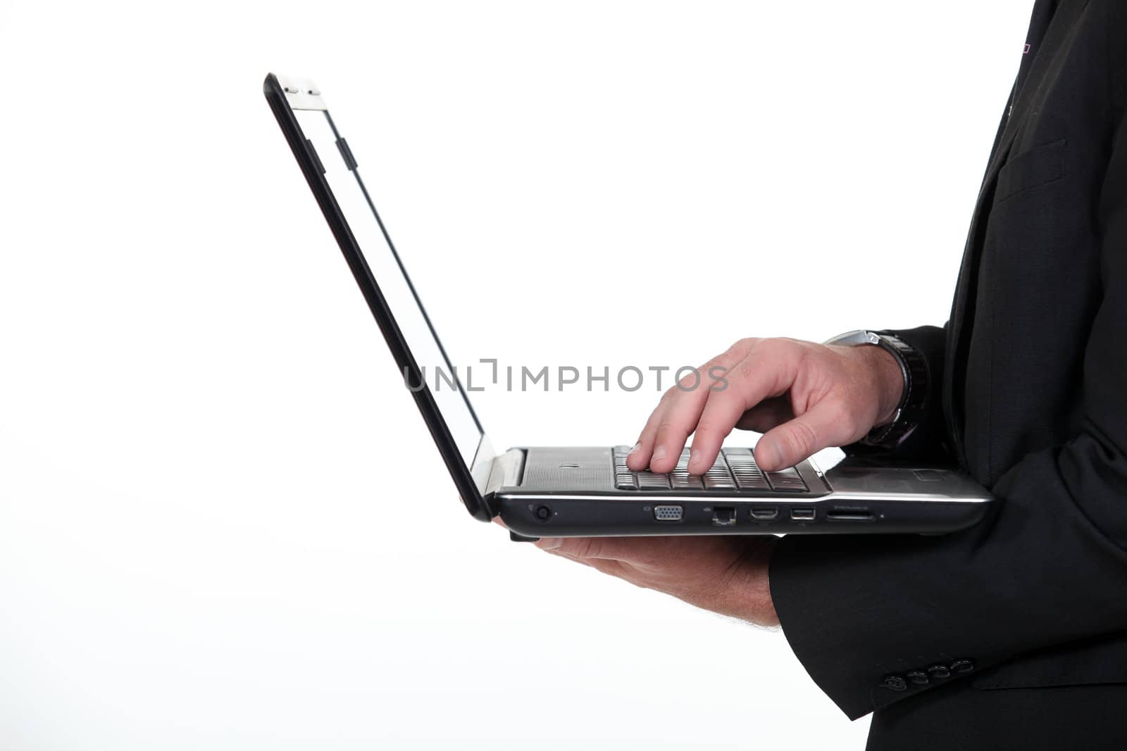 Profile of a businessman with a laptop by phovoir