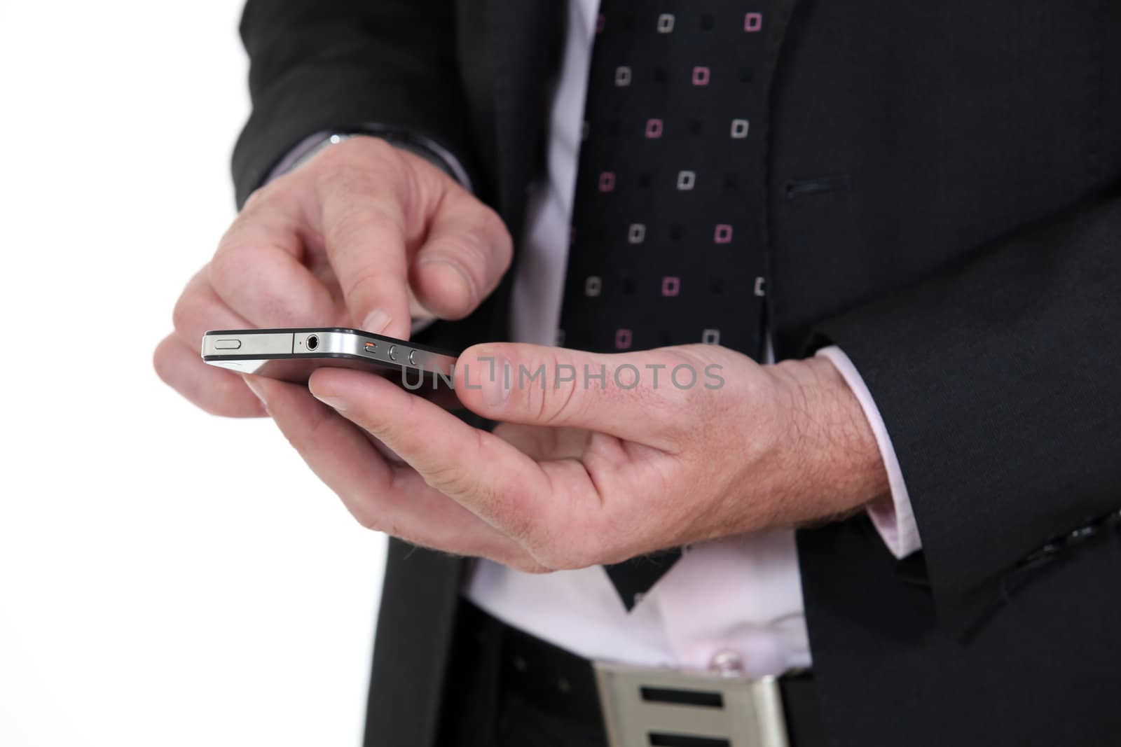 Businessman using a smartphone by phovoir