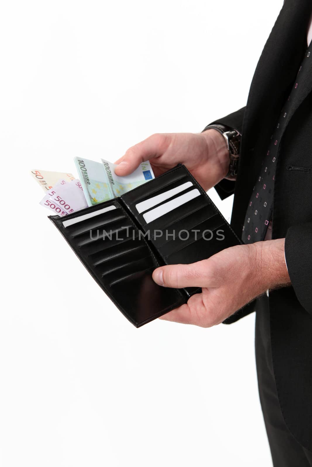 Businessman pulling out a wad of money from his wallet