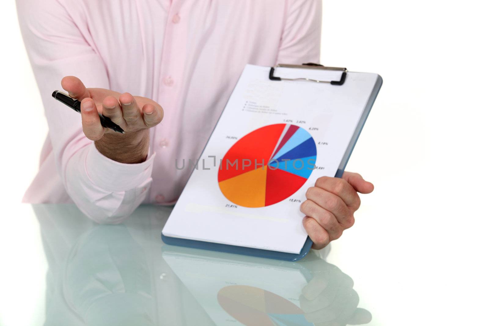 businessman showing pie chart at meeting by phovoir