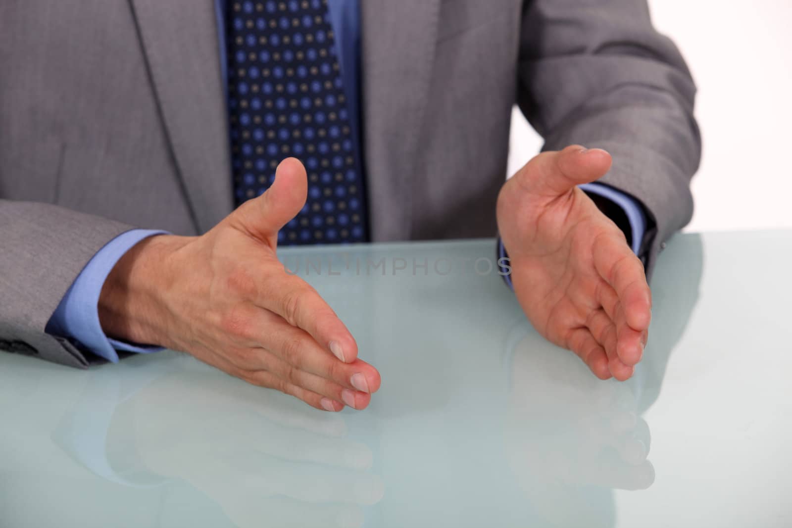 Businessman's hands on a desk by phovoir
