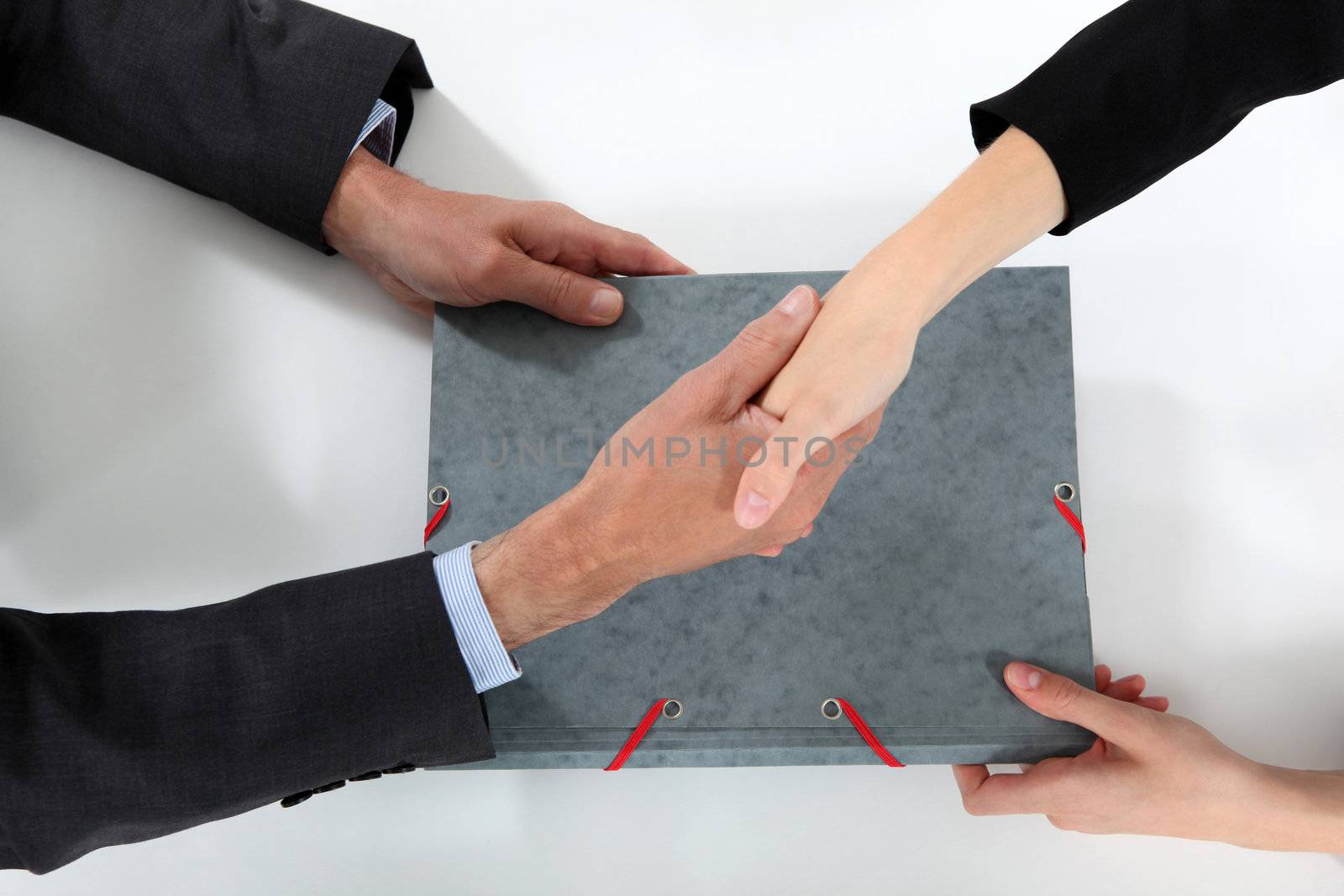 Businesspeople making a deal by phovoir