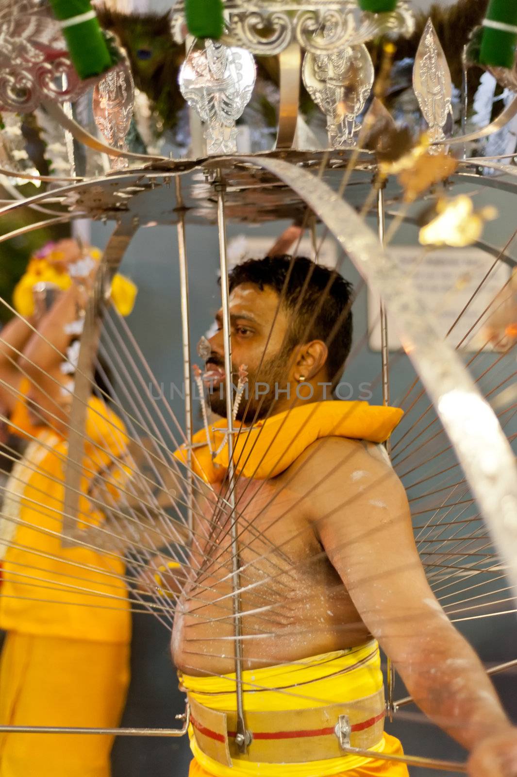 Devotee carrying a kavadi at Thaipusam in Singapore EDITORIAL US by 3523Studio