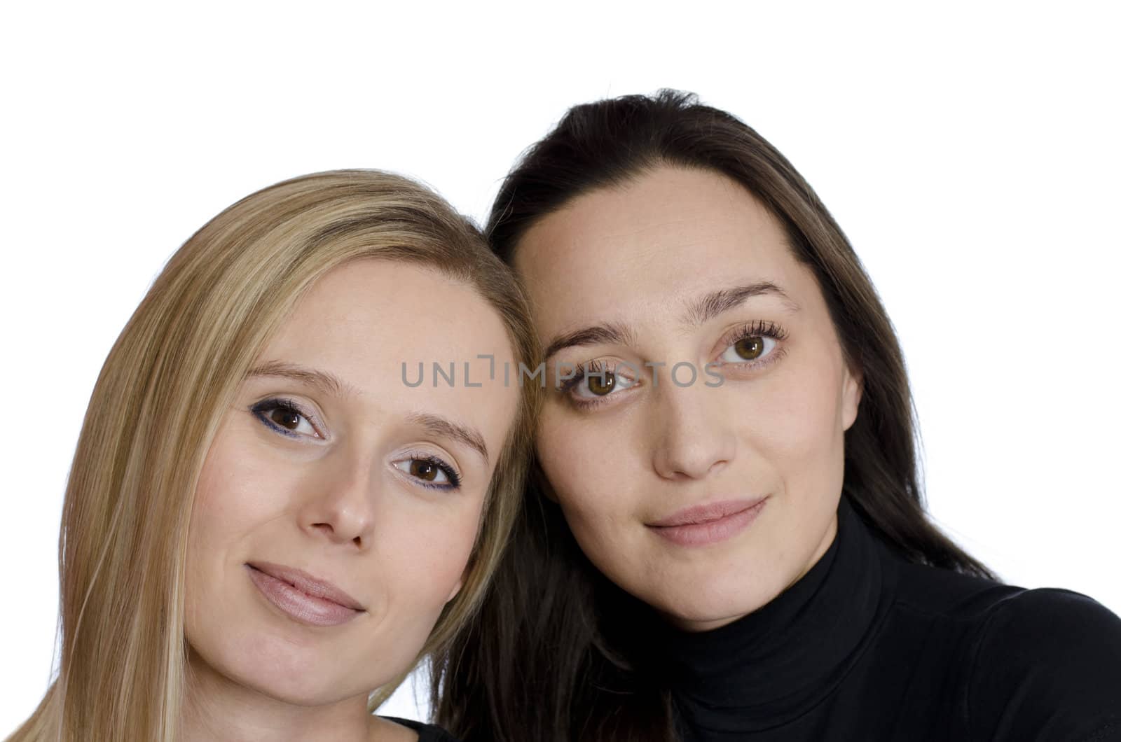 two girls one blonde and one brunette smiling on a white background