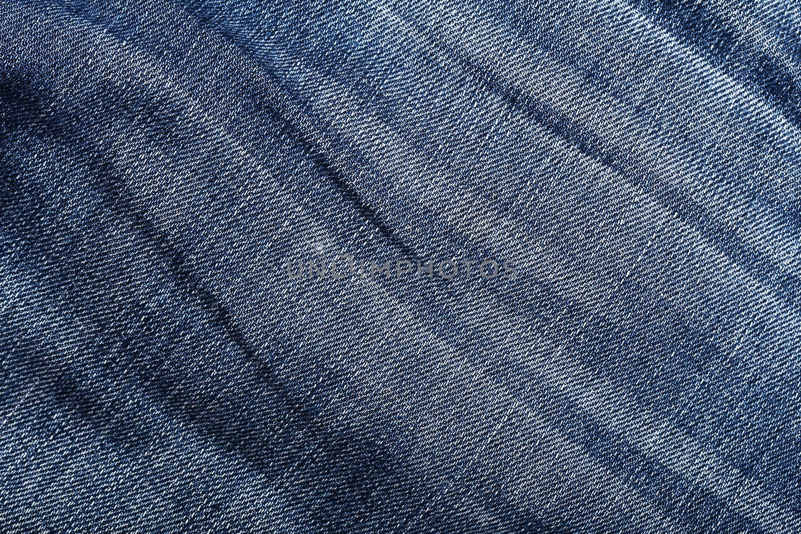 Wrinkled  worn jeans texture. Background. Close up