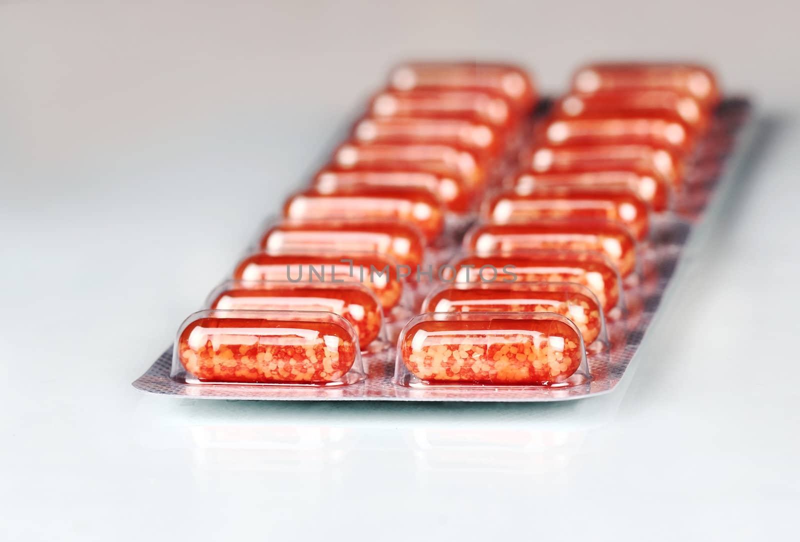 Pack of red pills isolated. Medical background