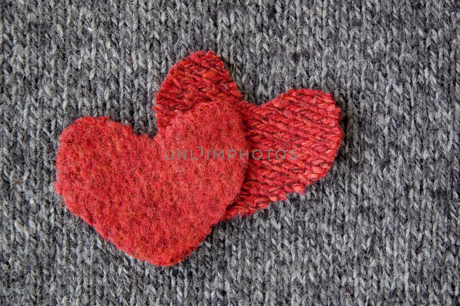 two red hearts put on dark fabric