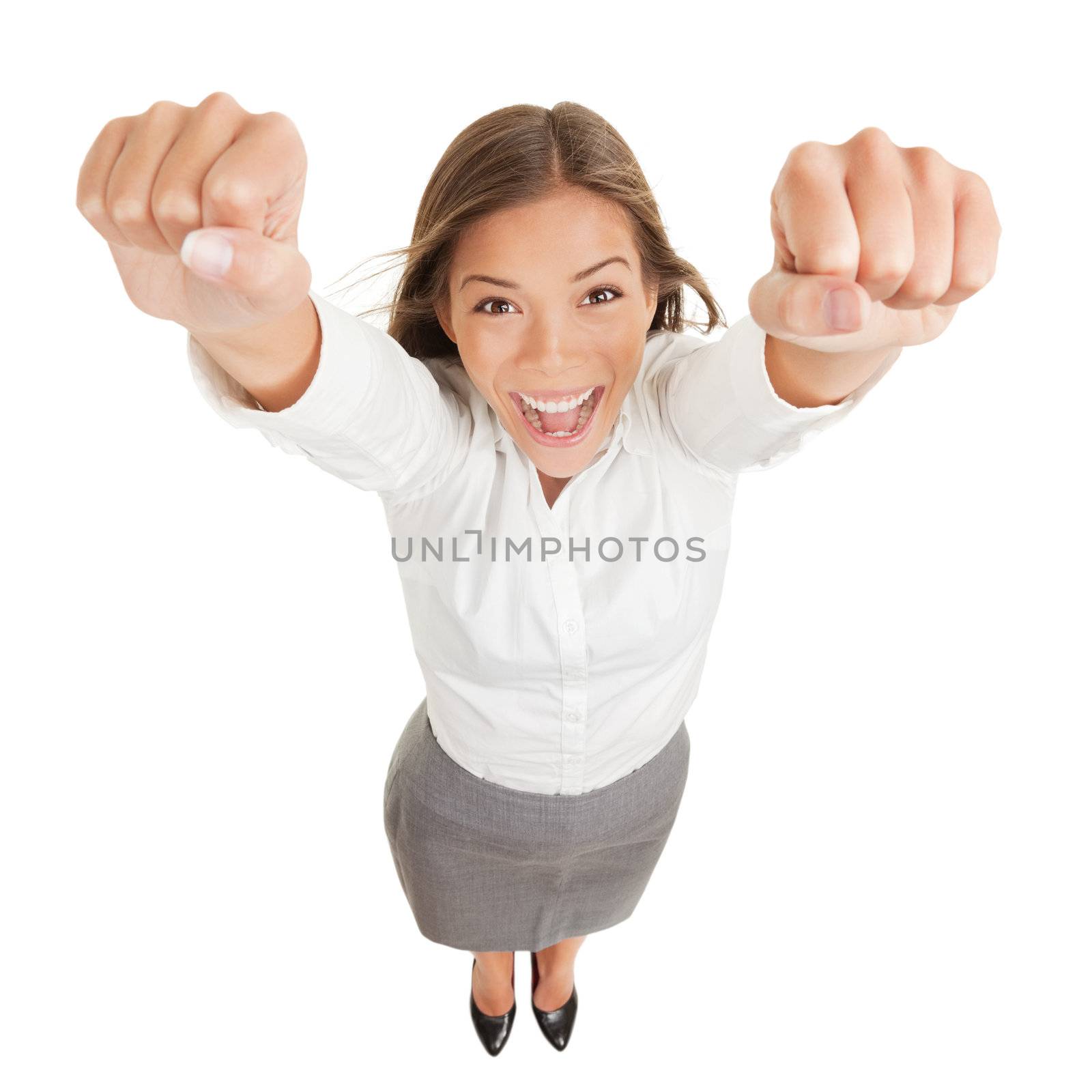 Happy jubilant you woman cheering. Fun high angle perspective of a vivacious jubilant you woman cheering and raising her clenched fists arms to the camera in her excitement isolated on white