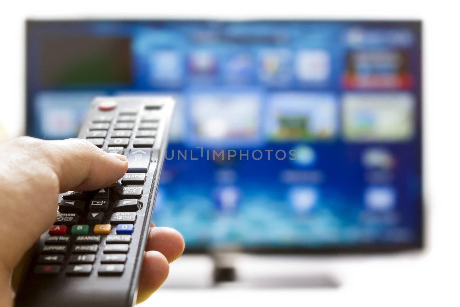 Television remote control changes channels thumb on the blue TV screen