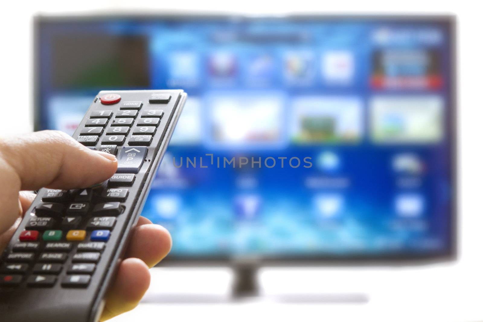 Smart tv and hand pressing remote control by manaemedia