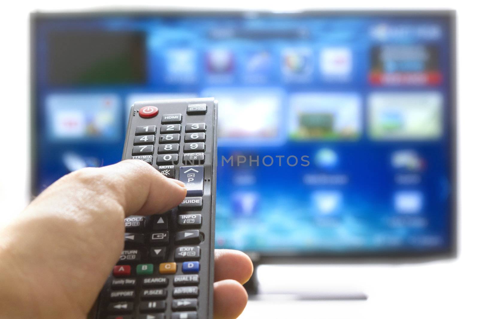 Smart tv and hand pressing remote control by manaemedia