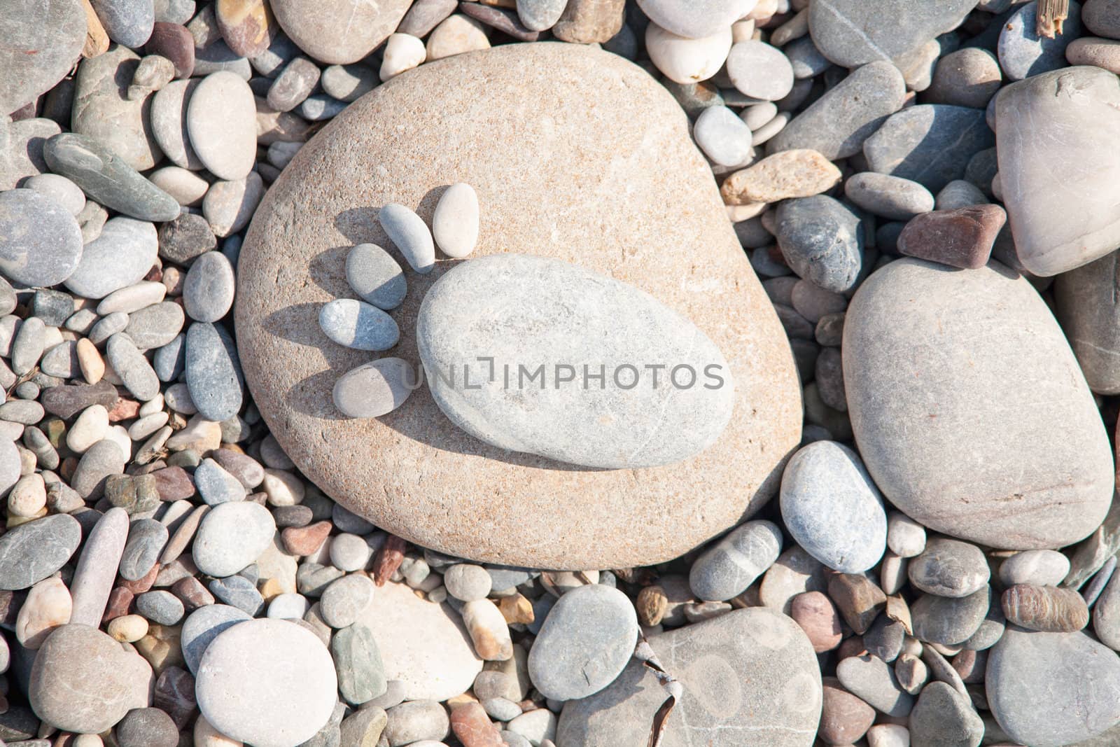 sea ​​stones laid out in the form of foot prints