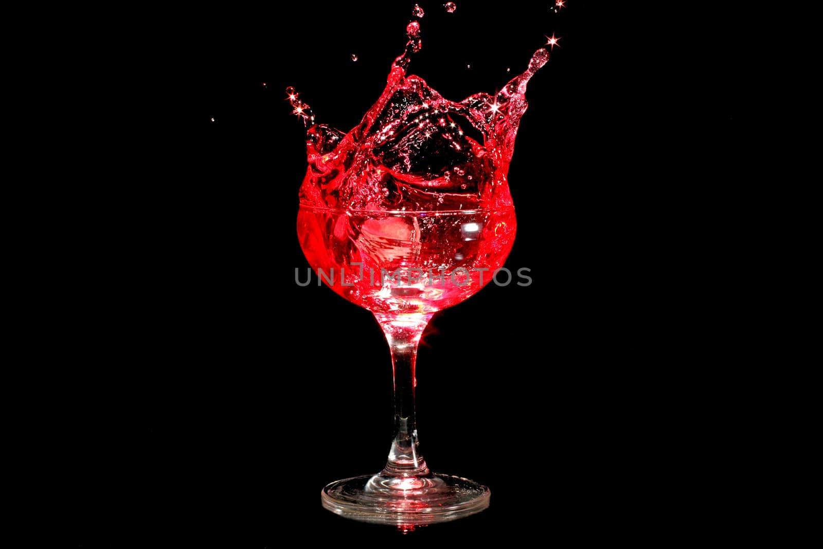 Ice cube splashing in a glass of wine