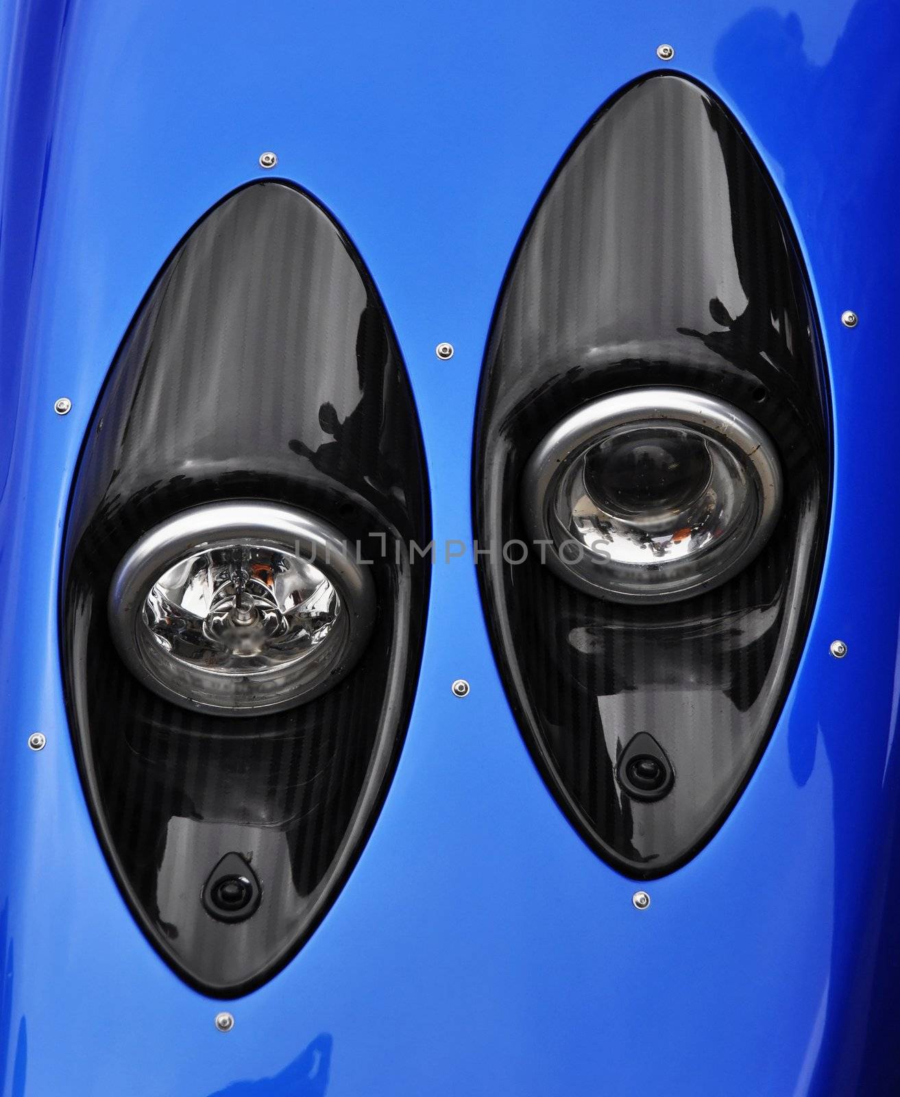 Supercar headlight, carbon fibre casing and blue bodywork