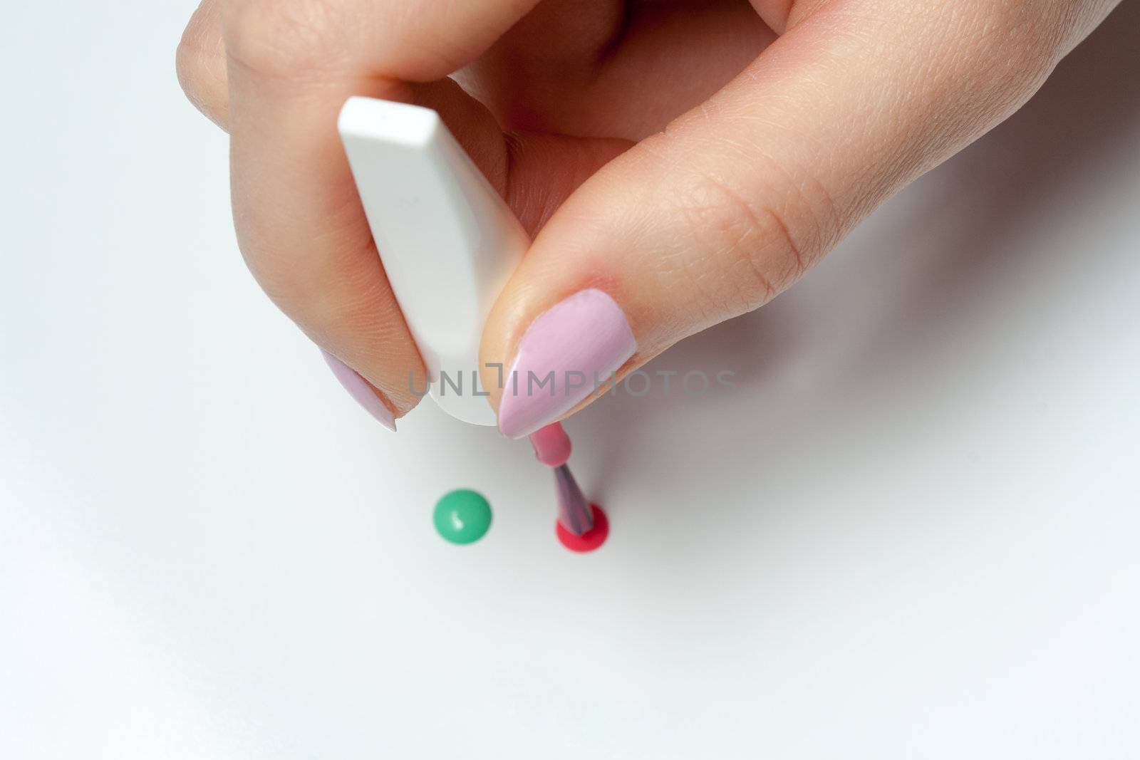 woman's hand with a brush of nail polish