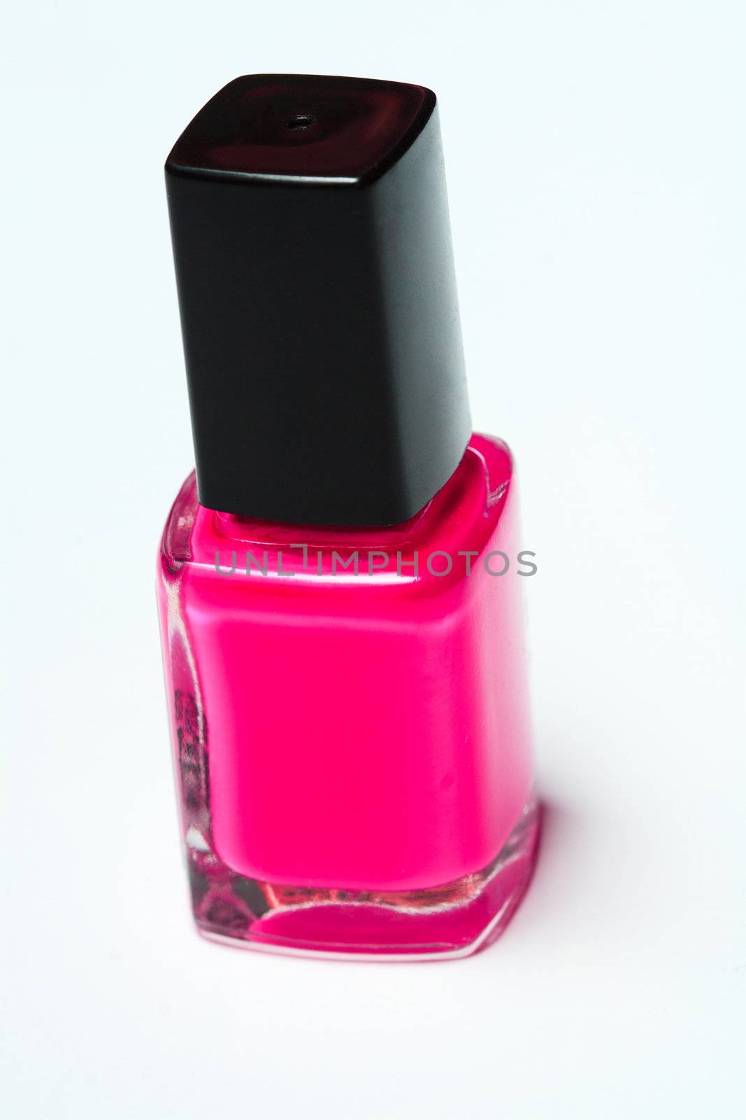 Pink nail polish on white background