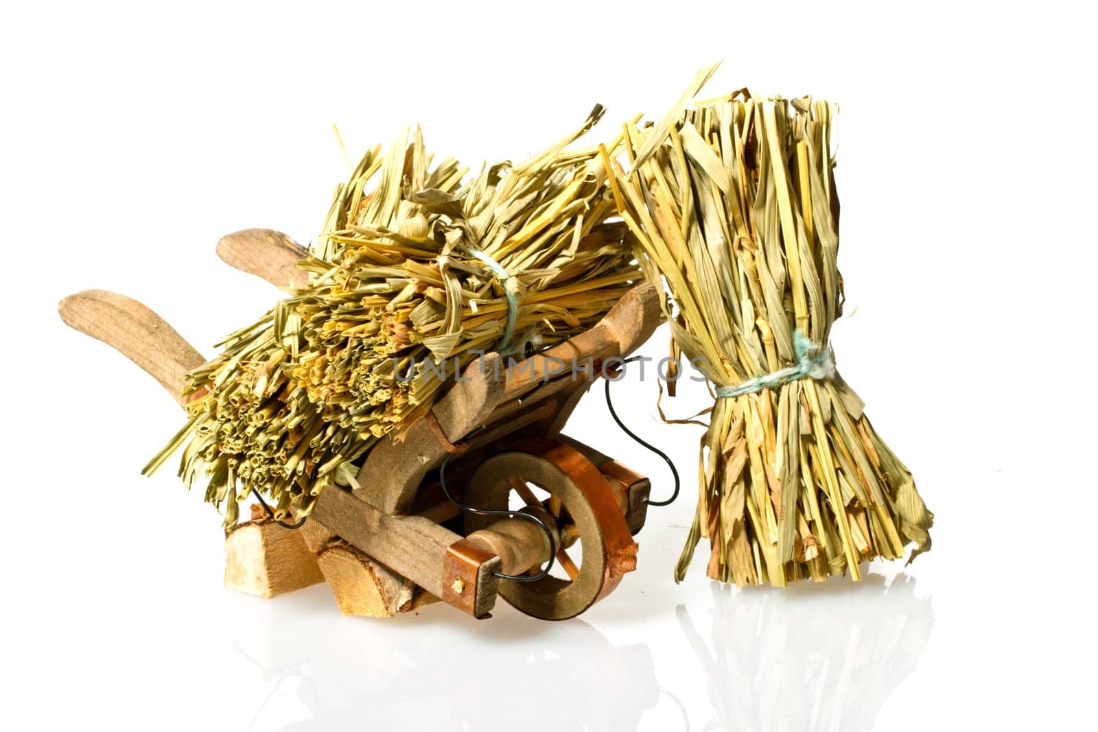 Handcart with straw on a white background
