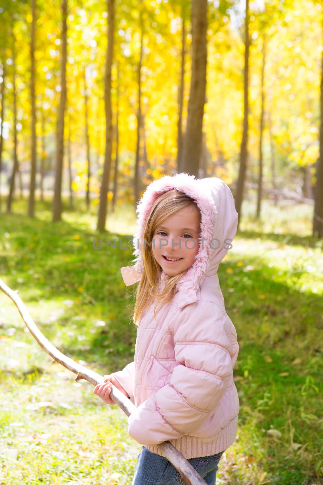 Explorer girl with stick in poplar yellow autumn forest by lunamarina