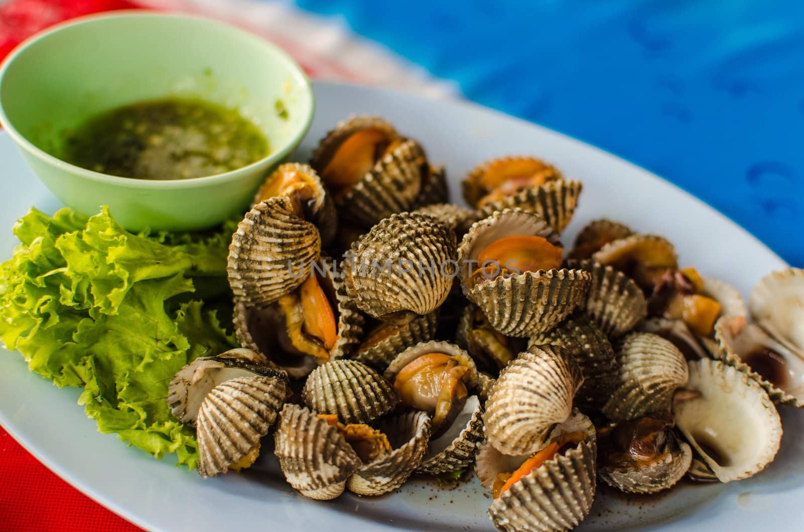 scallop Blanched seafood eaten with a dipping sauce.