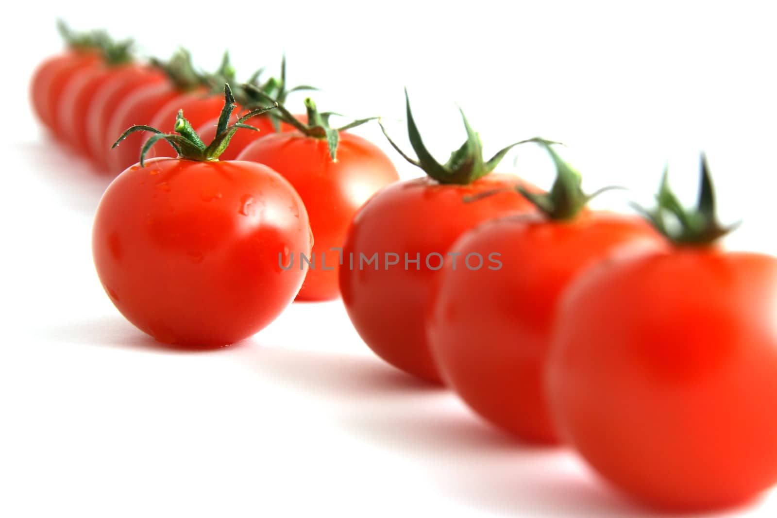 one step forward by one tomato, isolated on white