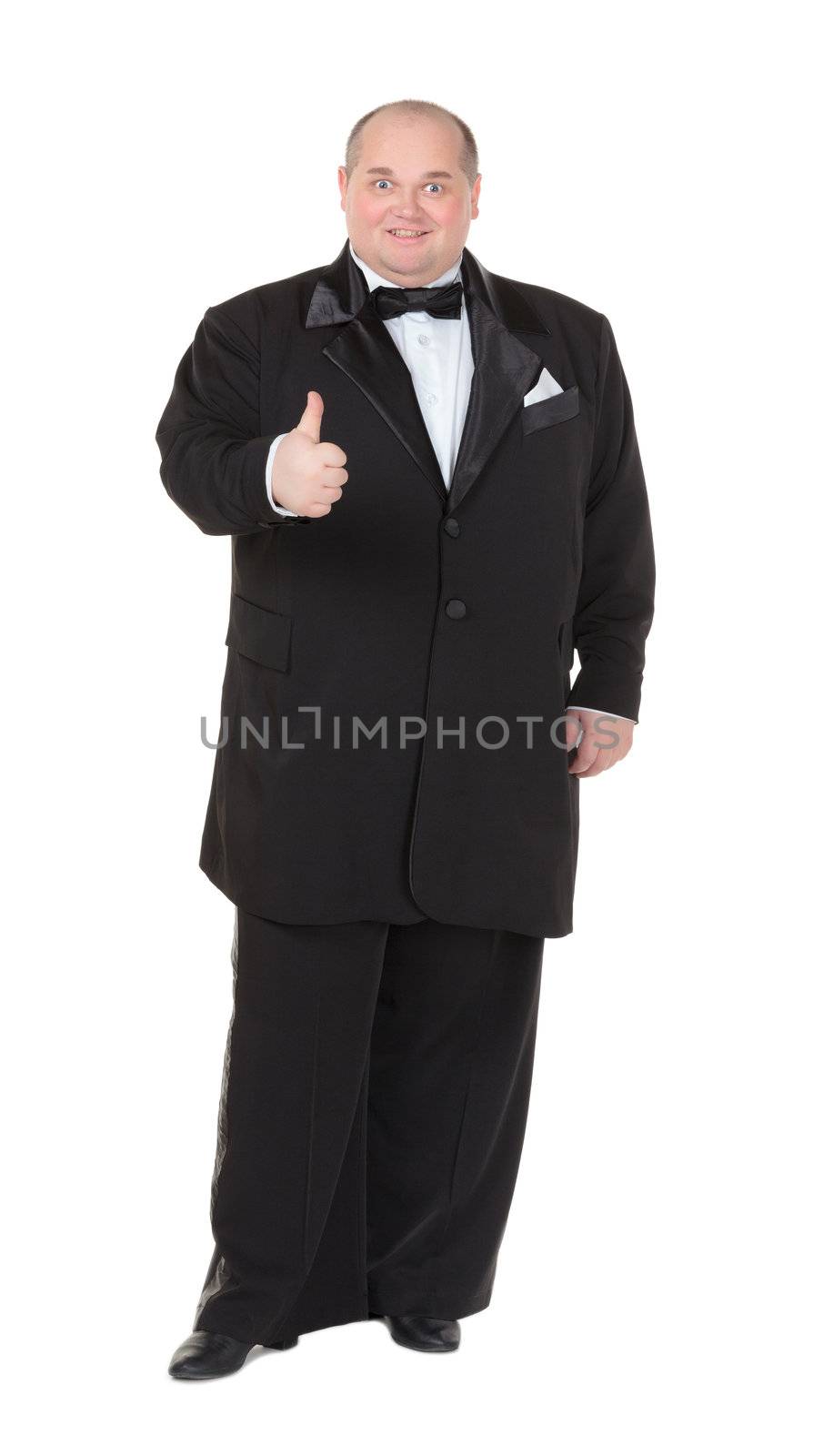 Elegant very fat man in a tuxedo and bow tie shows thumb-up, on white background