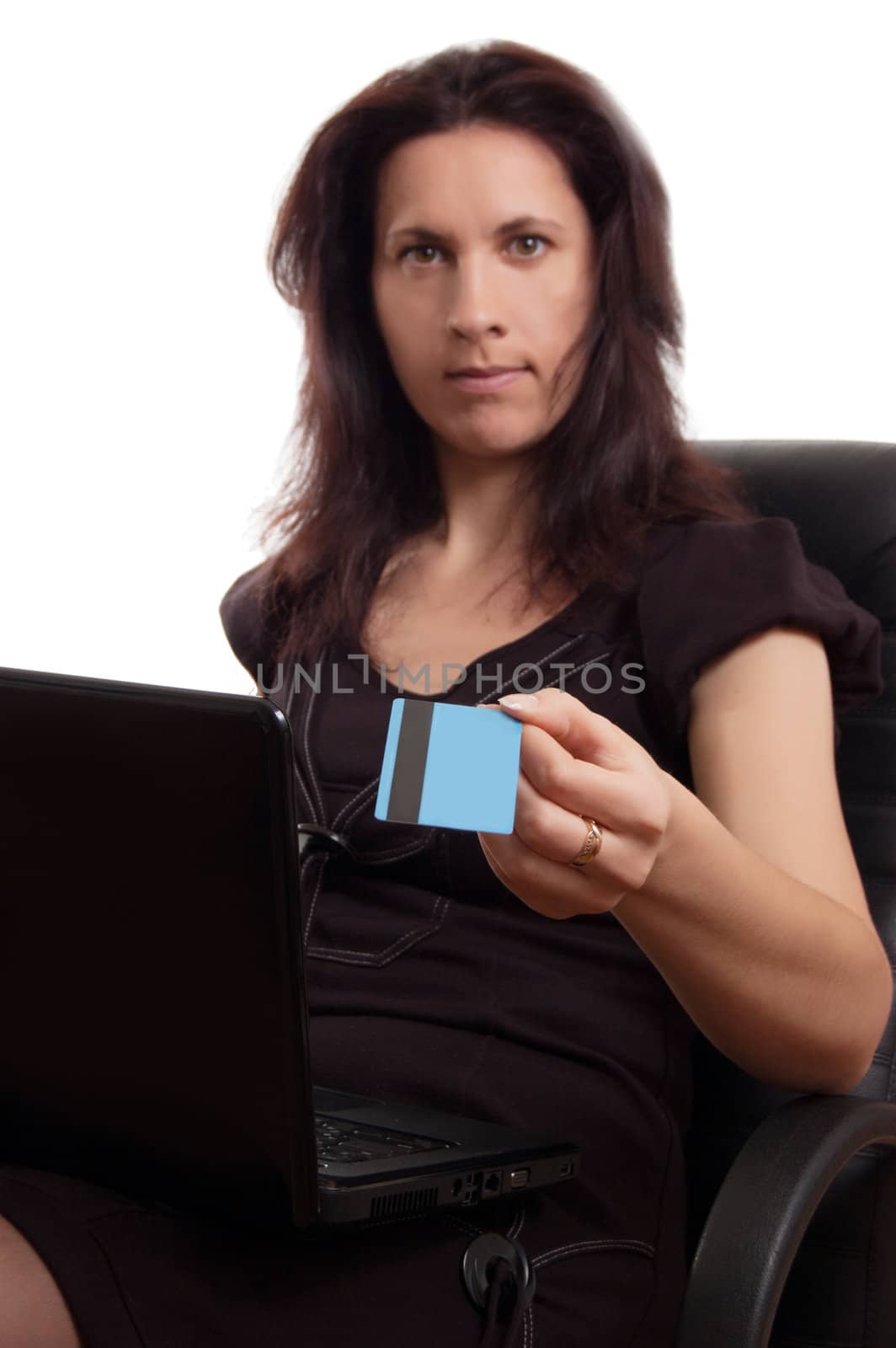 Serious woman holding credit card with laptop over white, focus on card