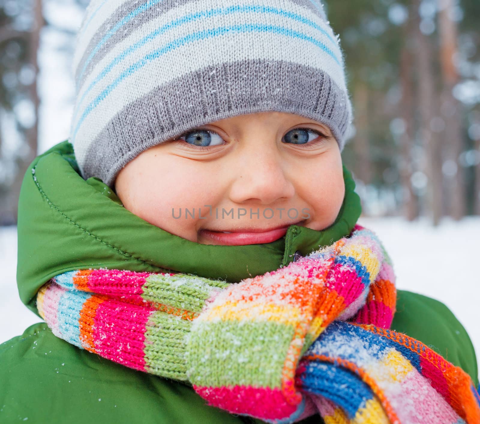 Portrait of a little baby boy in winter forest.