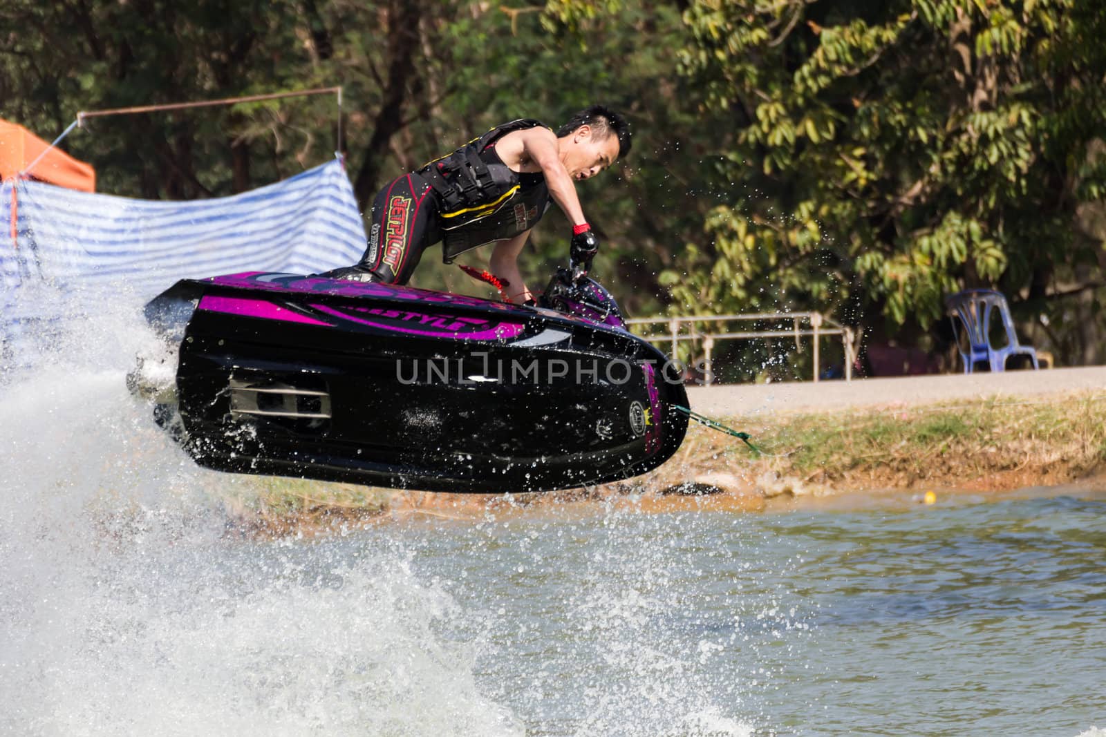 SARABURI THAILAND-JANUARY 20: Somchai Sae-Tang in action during show Freestyle the Jet ski  stunt action  on Jan 20, 2013 in SARABURI,Thailand.
