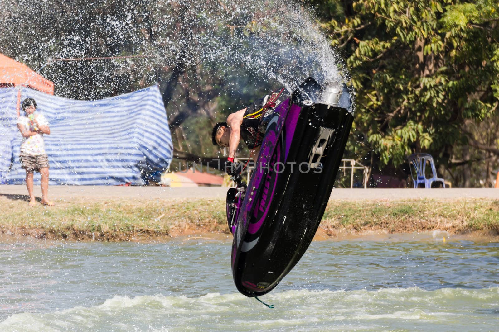 SARABURI THAILAND-JANUARY 20: Somchai Sae-Tang in action during show Freestyle the Jet ski  stunt action  on Jan 20, 2013 in SARABURI,Thailand.
