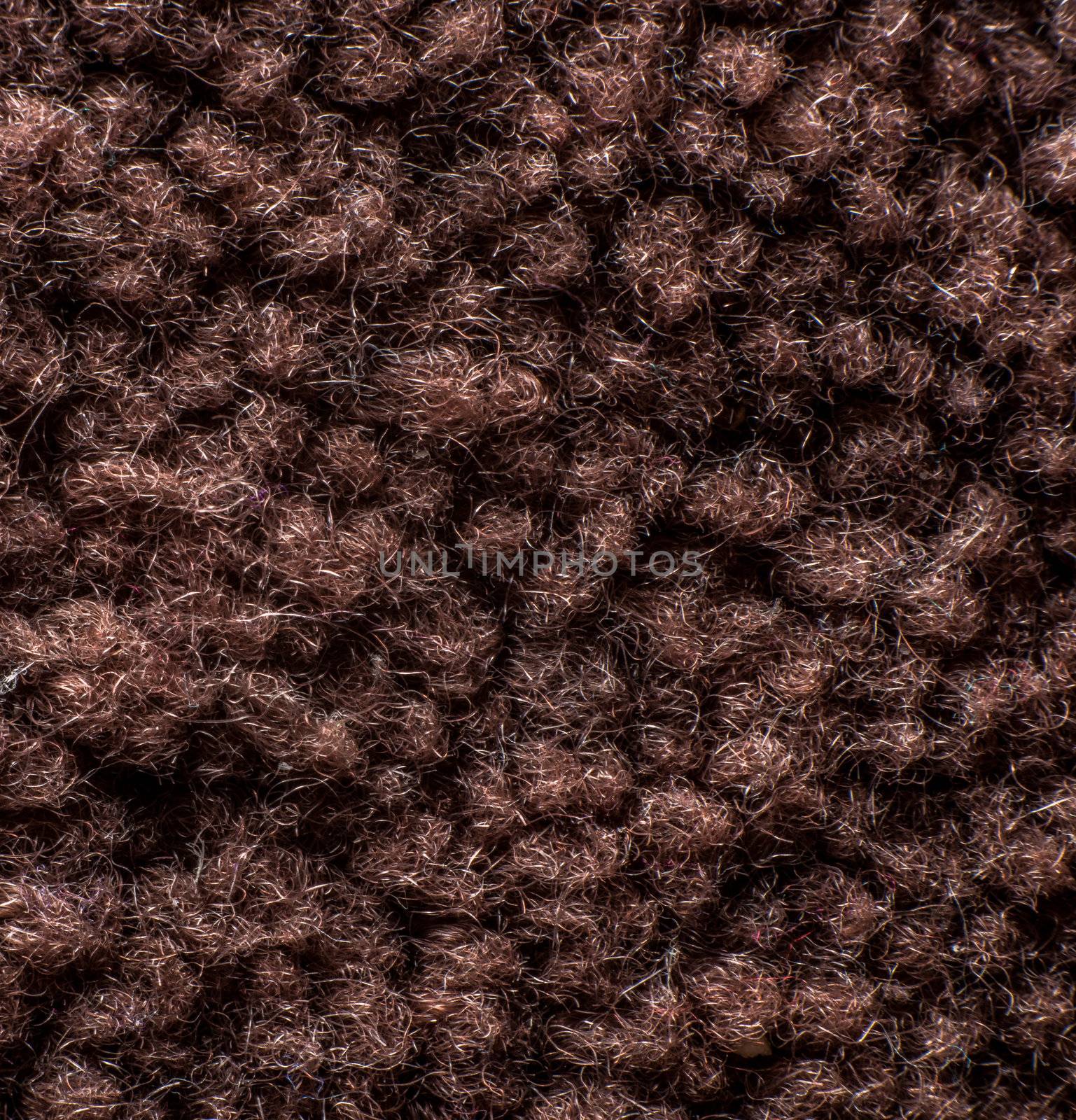 Texture of carpet or a rug up close showing all the fibres