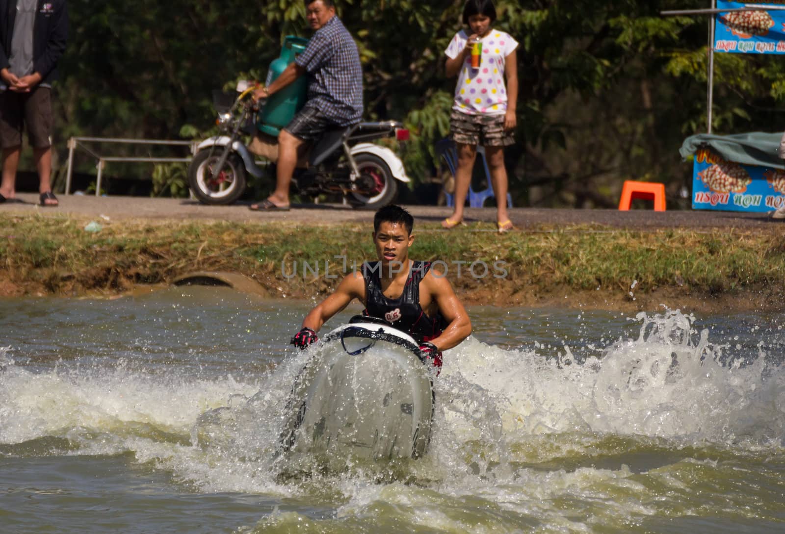 SARABURI THAILAND-JANUARY 20: Veerapong Maneechom in action during show Freestyle the Jet ski  stunt action  on Jan 20, 2013 in SARABURI,Thailand.