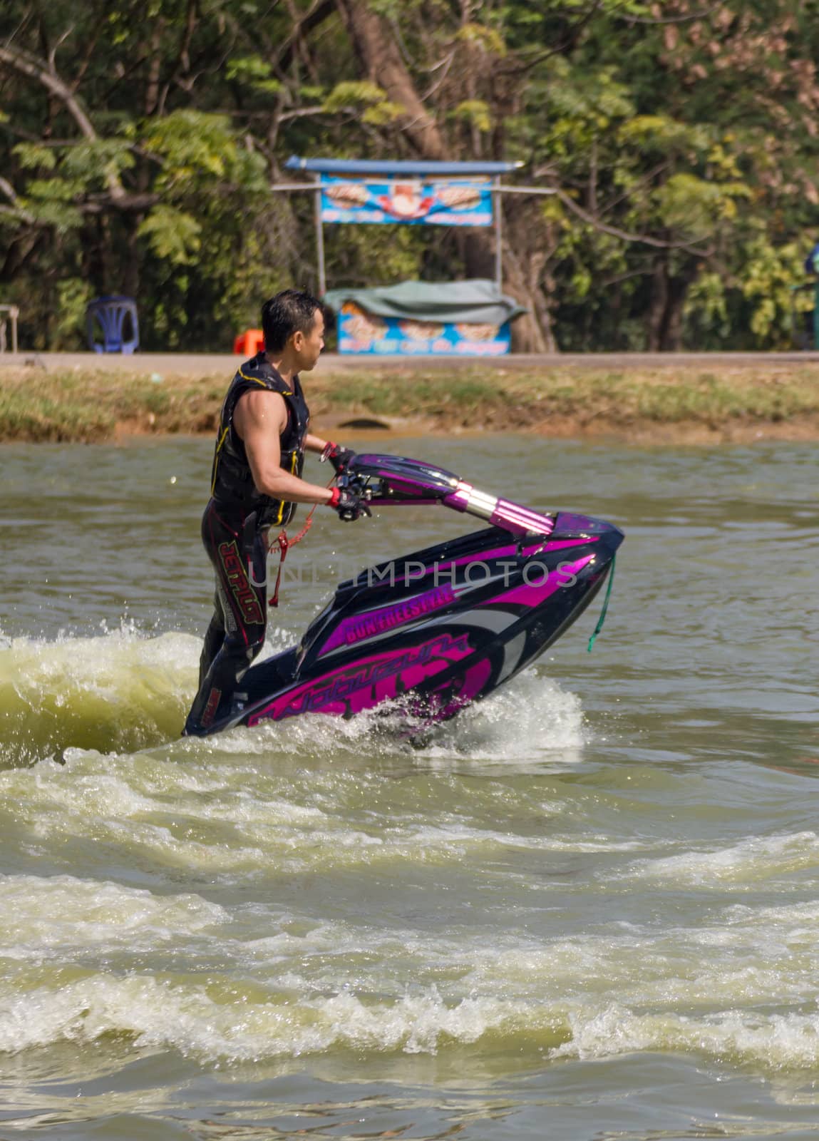 SARABURI THAILAND-JANUARY 20: Somchai Sae-Tang in action during show Freestyle the Jet ski  stunt action  on Jan 20, 2013 in SARABURI,Thailand.