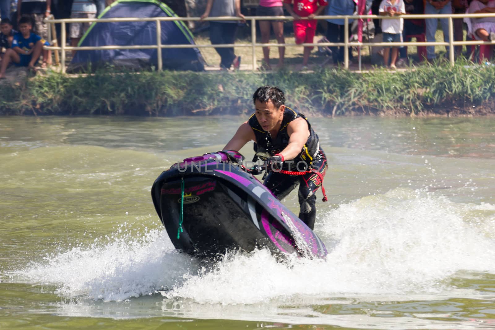 SARABURI THAILAND-JANUARY 20: Somchai Sae-Tang in action during show Freestyle the Jet ski  stunt action  on Jan 20, 2013 in SARABURI,Thailand.
