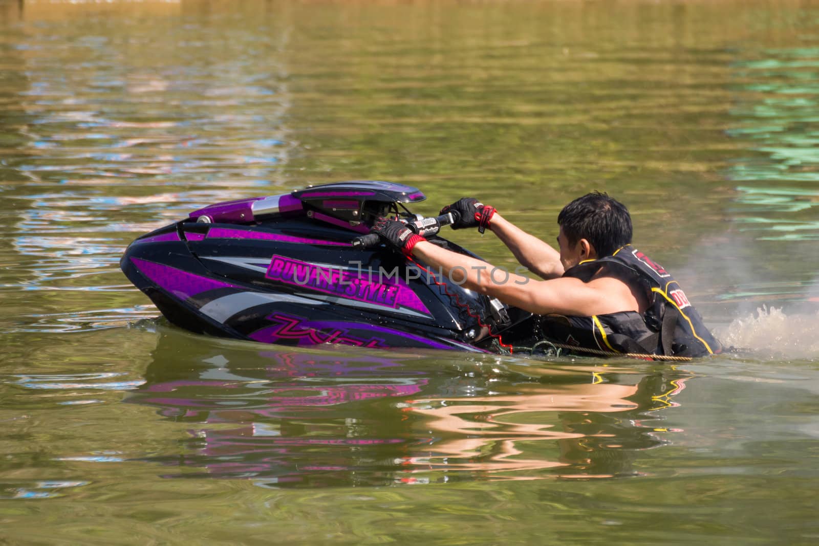 SARABURI THAILAND-JANUARY 20: Somchai Sae-Tang in action during show Freestyle the Jet ski  stunt action  on Jan 20, 2013 in SARABURI,Thailand.