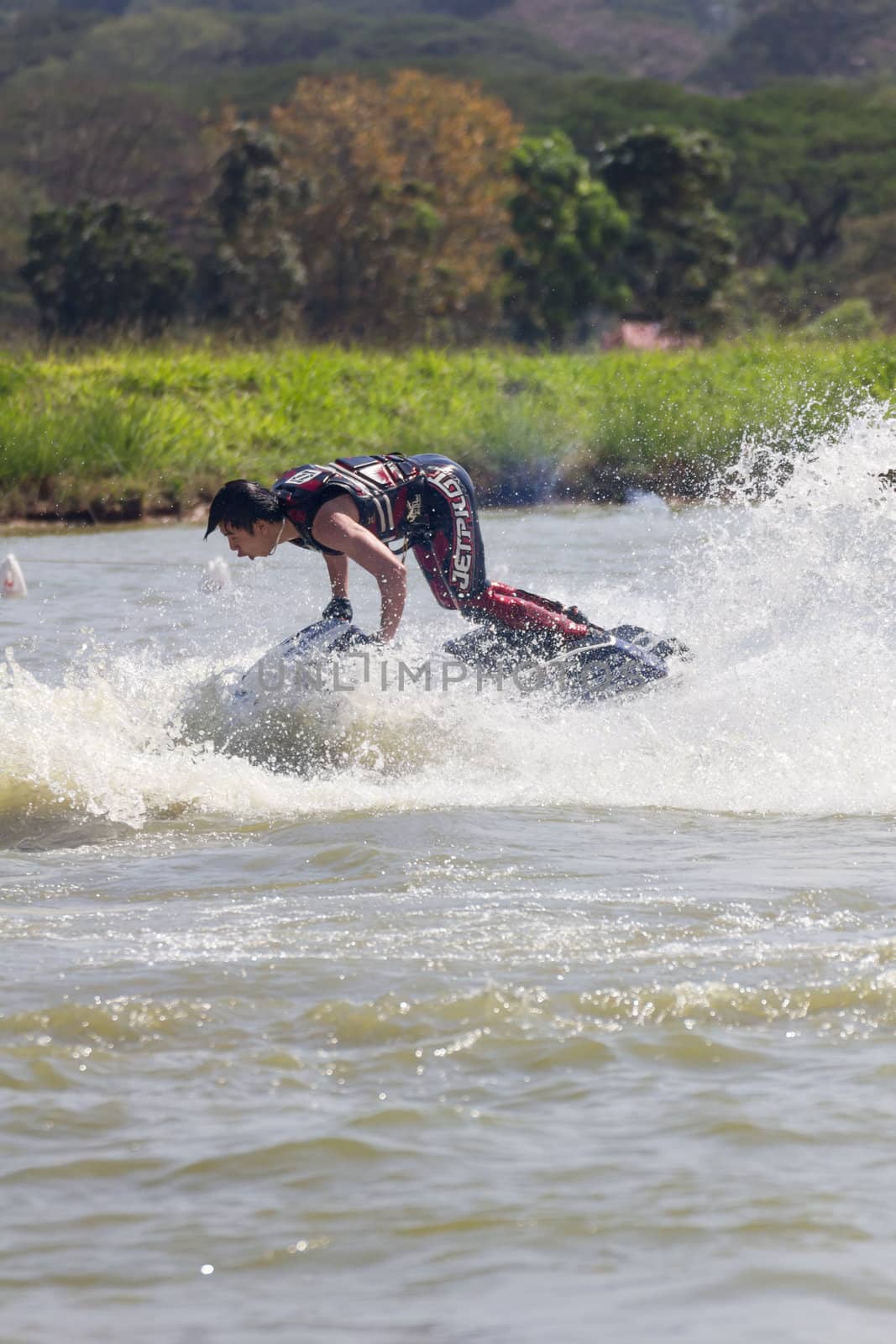 SARABURI THAILAND-JANUARY 20: Sonswut Rappasubpisan in action during show Freestyle the Jet ski  stunt action  on Jan 20, 2013 in SARABURI,Thailand.