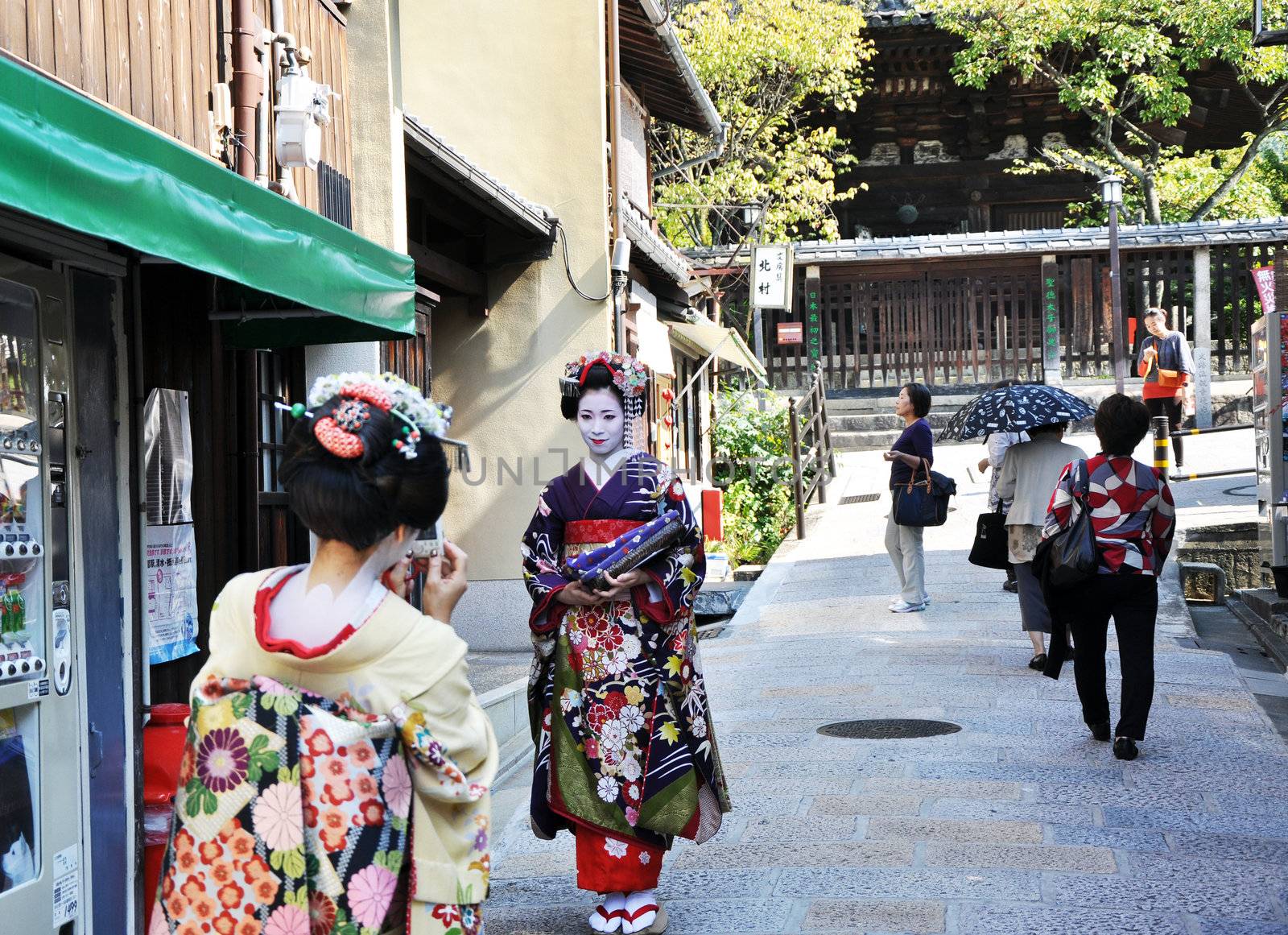 KYOTO, JAPAN - OCT 21 2012: Japanese ladies in traditional dress by siraanamwong