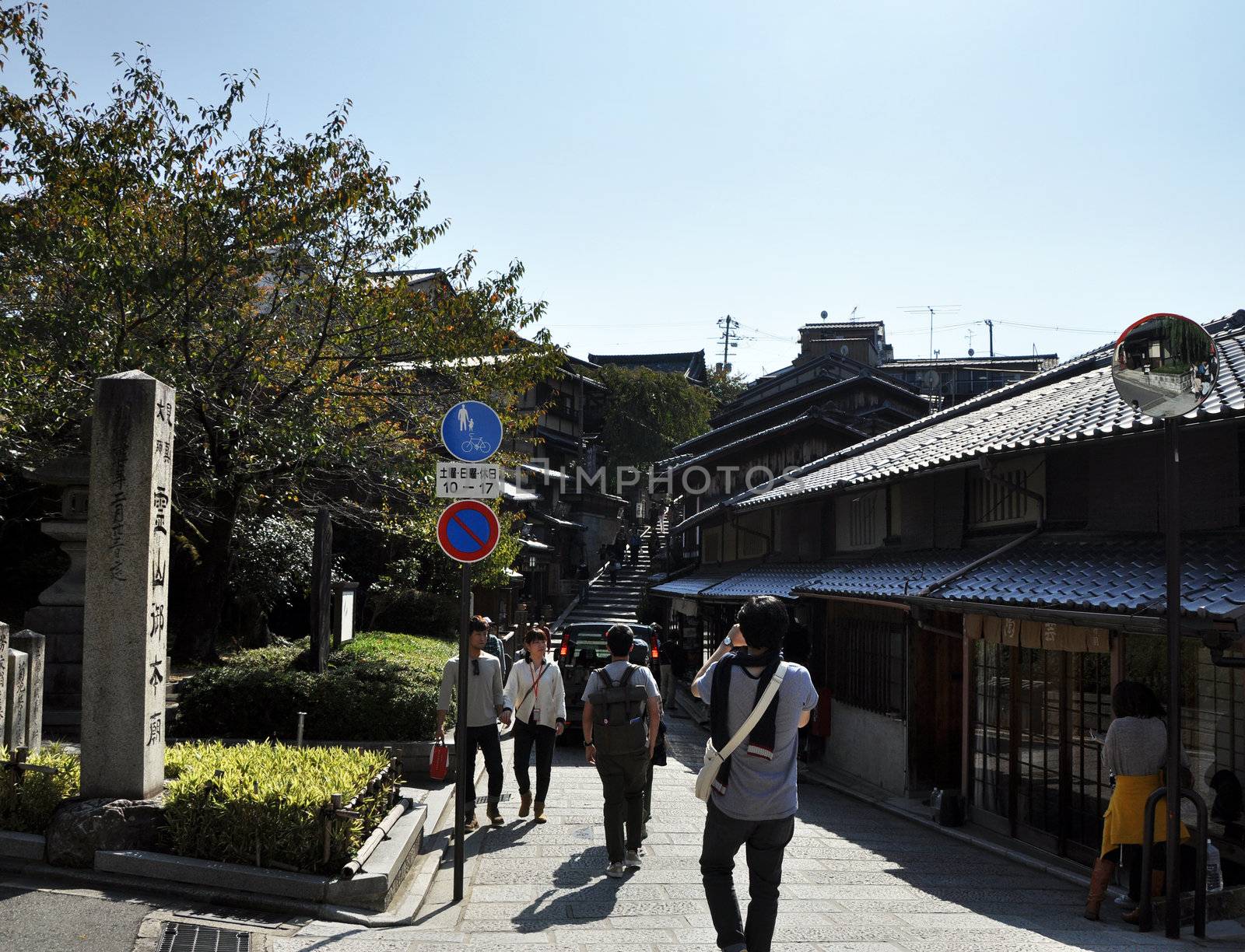 KYOTO, JAPAN - OCT 21 2012: Tourists walk on a street by siraanamwong